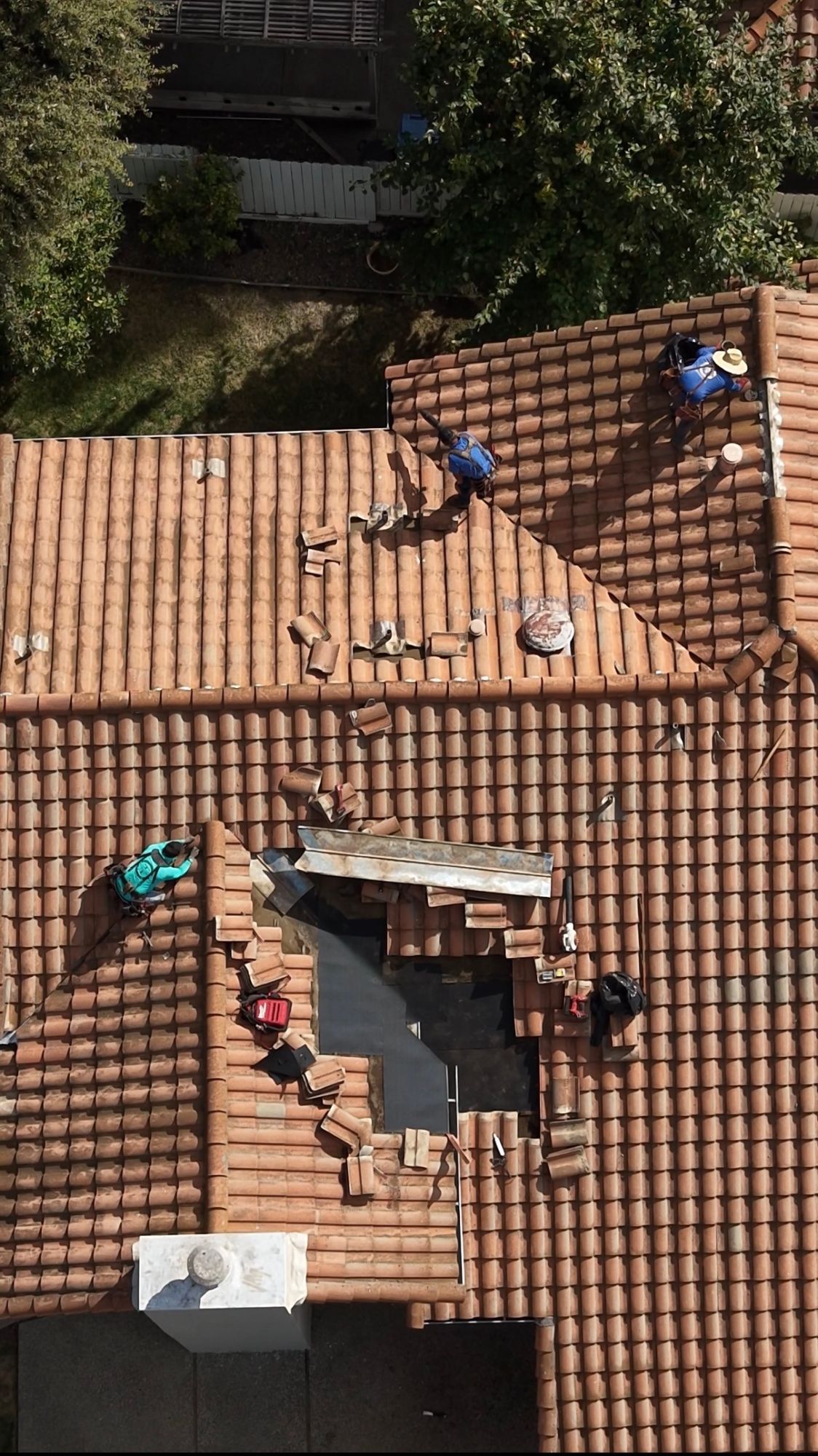 Aerial view of a Triple R crew repairing a tile roof.