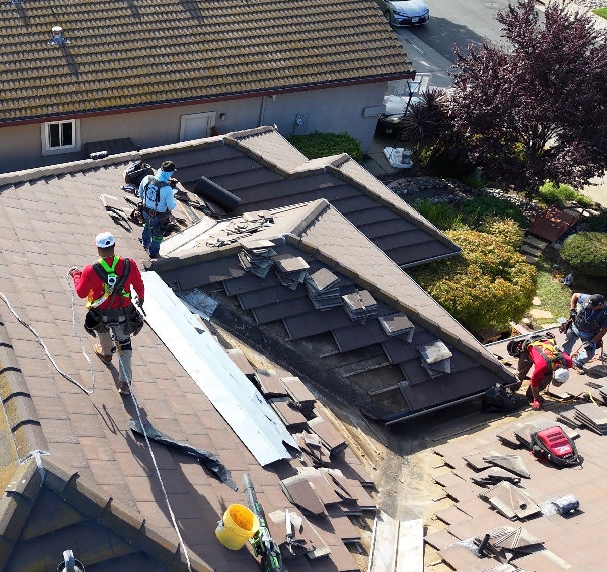 A Triple R crew tearing off and replacing a tile roof.